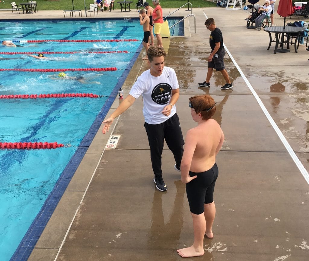 Abbie Fish explaining the crossover turn to a young swimmer.