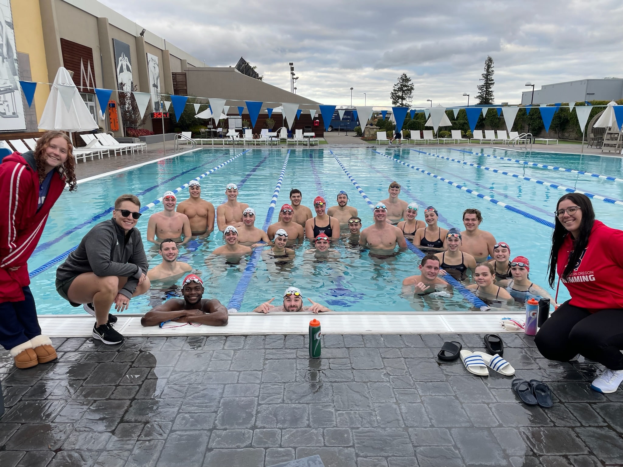Swim Like A Fish coach meeting with swimmers before practice to review Backstroke rules and technique goals.