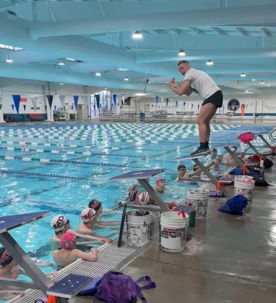 Abbie Fish coaching Breaststroke technique during an on-deck swim coach session