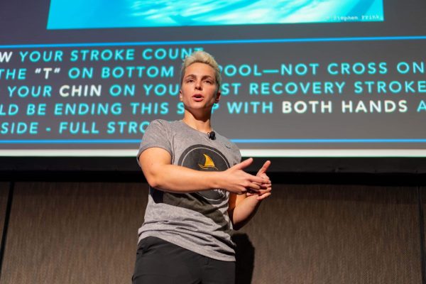 Abbie Fish public speaking during a Swim Like A. Fish swim clinic.